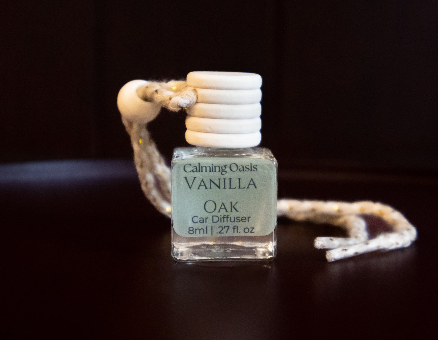 Vanilla Oak car diffuser on a dark background