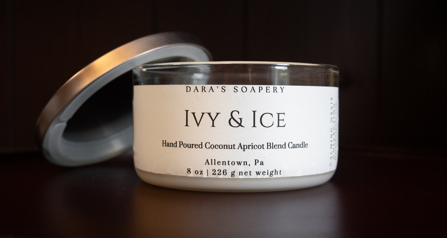 Candle jar labeled 'Ivy & Ice' from Dara's Soapery on a dark background